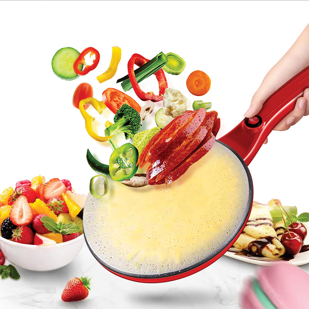 Red crepe maker pan with food and vegetables on a white background